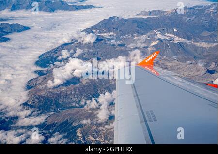 Genf Schweiz -17.09.2021: Blick aus dem Flugzeug. EasyJet Flugflügel, Berge und Wolkenmeer. Reisen. Stockfoto