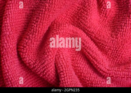 Nahaufnahme von rosa gestrickten strukturierten Hintergrund. Trendige Farbe des Jahres 2022. Stockfoto