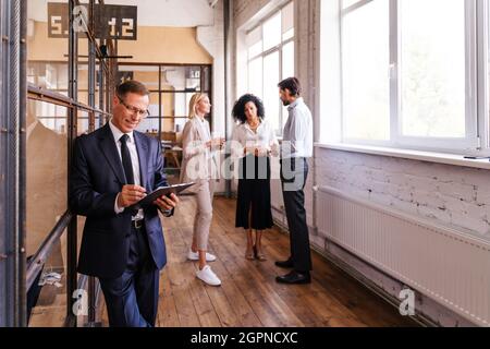 Multiethnisches Unternehmensteam im Büro für einen strategischen Marketingplan - Büroangestellte, Unternehmer und Mitarbeiter des Unternehmens bei der Arbeit Stockfoto