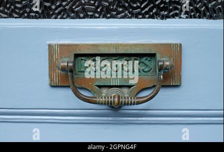 Verwitterter messingbriefkasten im viktorianischen Stil auf blau lackierter Haustür, yorkshire, england Stockfoto