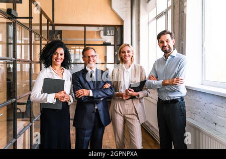 Multiethnisches Unternehmensteam im Büro für einen strategischen Marketingplan - Büroangestellte, Unternehmer und Mitarbeiter des Unternehmens bei der Arbeit Stockfoto