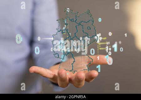 Nahaufnahme eines 3d-gerenderten Hologramms einer Karte von Deutschland in Menschenhand Stockfoto
