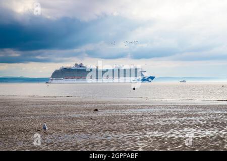 Das 'Regal Princess'-Kreuzschiff, das Liverpool auf dem Fluss Mersey abfährt und an den Antony Gormley-Statuen 'Another Place' am Crosby Beach vorbeifährt. Stockfoto