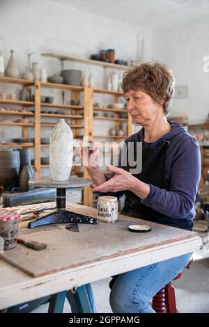 Spanien, Balearen, Frau Malerei Keramik in der Werkstatt Stockfoto