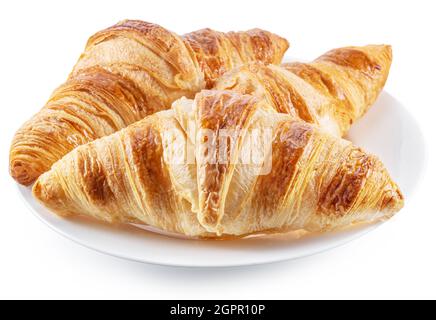 Leckere knusprige Croissants auf dem Teller auf weißem Hintergrund. Stockfoto