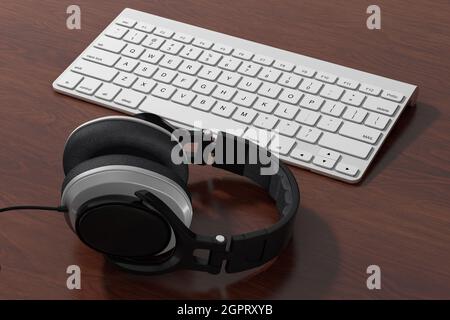 Schwarze Kopfhörer mit weißer Computertastatur auf einem Holztisch. 3d-Rendering Stockfoto