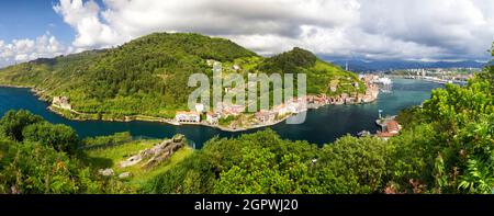 Blick auf das Fischerdorf mit seiner Uferpromenade und Booten in Pasai Donibane, Gipuzkoa, Baskenland, Spanien Stockfoto