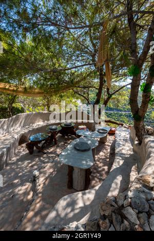 Maßgeschneiderte künstlerische Sitzgelegenheiten in der Taverne in den damianos Höhlen auf der griechischen ferieninsel zakynthos. Tische und Bänke Sitzmöbel aus Treibholz. Stockfoto