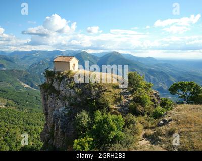 LUFTAUFNAHME mit einem 6-Meter-Mast. Kleine Kapelle neugierig auf dem Rand einer steilen Klippe thront. Kapelle von Saint-Michel de Cousson, Frankreich. Stockfoto