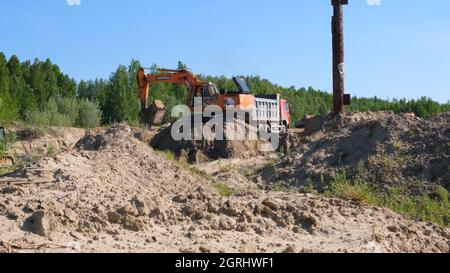 Yellow Bulldozer führt Erdarbeiten durch Sandgraben auf einer Baustelle: Moskau, Russland - 30. August 2021. Stockfoto