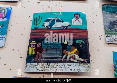 ANTIGUA, GUATEMALA - 26. MÄRZ 2016: Retablo Lamina , Andachtsgemälde einer mexikanischen Volkskunst. Es geht um den Drogenschmuggel in die USA. Stockfoto