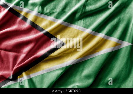Winkende detaillierte Nationalflagge von Guyana Stockfoto
