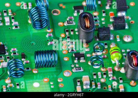 Elektronische Bauteile zum Empfang von Hochfrequenzsignalen, grüne Leiterplatte. Planare Spiralspule in Leiterplattenschicht, Luftspulen in TV-Karte. Stockfoto