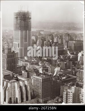 EMPIRE STATE BUILDING NY, NY 1930 - 1931. Allgemeine und detaillierte Ansichten des im Bau befindlichen Empire State Building, in denen Arbeiter verschiedene Aufgaben wie das Positionieren, Schweißen und Nieten von Stahl, das Heben von Materialien und Hilfsgütern sowie das Betreiben und Reparieren von Maschinen zeigen. Es gibt auch eine Vogelperspektive auf Midtown Manhattan, die andere Gebäude zeigt, die im Bau sind. Fotografien von: Hine, Lewis Wickes, 1874-1940 . Stockfoto