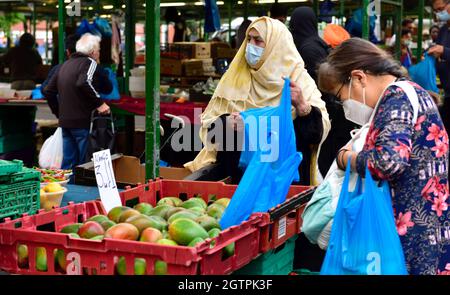 Shopper, die auf der Suche nach Obst und Gemüse im Birmingham Bullring Open Market sind Stockfoto