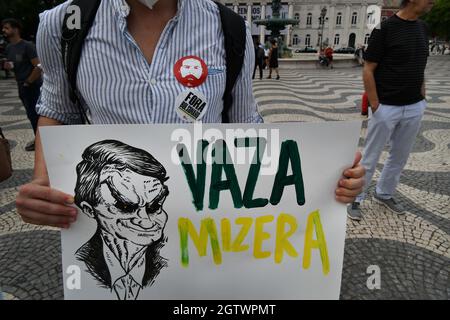 Lissabon, Portugal. Oktober 2021. Ein Aktivist hält ein Plakat, das den brasilianischen Präsidenten Jair Bolsonaro während einer Kundgebung auf dem Rossio-Platz ablehnt. Die in Lissabon verschiedene Organisationen, Parteien, Gewerkschaften und Bewegungen für Demokratie und die Rechte des Volkes zusammenbringt, veranstaltete eine Kundgebung zur Ablehnung der Politik des brasilianischen Präsidenten Jair Bolsonaro und forderte seinen Rücktritt als Staatsoberhaupt. (Foto von Jorge Castellanos/SOPA Images/Sipa USA) Quelle: SIPA USA/Alamy Live News Stockfoto