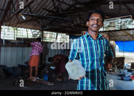 Aranmula, Indien - 5. Dezember 2015: Kerala. Silber Spiegel handgemachte Produktion in ländlichen Gebieten, macht der Mensch handgefertigte einzigartige Kunstwerke. Familie klein Stockfoto