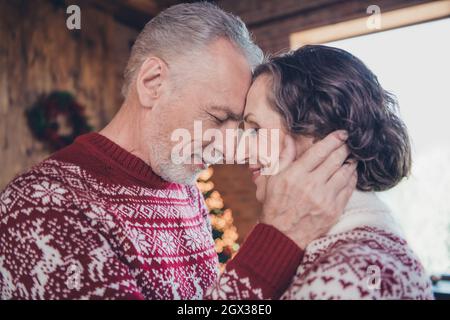 Fotoportrait Älteres Paar verbringt an Weihnachten gemeinsam Zeit in warmen Pullovern Stockfoto
