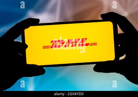 In dieser Abbildung ist ein DHL-Logo auf einem Smartphone zu sehen. Stockfoto