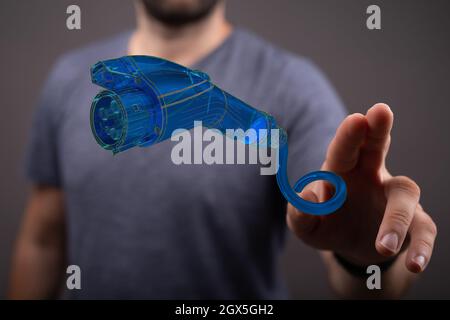 Person, die eine virtuelle 3D-gerenderte Projektion eines elektrischen Steckers präsentiert Stockfoto