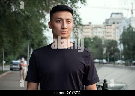 Aufnahme eines hübschen jungen Mannes, der nach einem morgendlichen Lauf in der Stadt einen Moment zum Atmen einnahm Stockfoto
