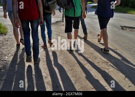 Kovrov, Russland. 12. August 2017. Teenager, die die Straße entlang laufen. Schatten von den Füßen auf der Straße Stockfoto