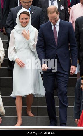 Catherine, Herzogin von Cambridge und Prinz William, Herzog von Cambridge, ziehen ihre Schuhe aus, als sie die Assyakirin-Moschee in Kuala Lumpur am 4. Tag einer Diamond Jubilee Tour durch den Fernen Osten besuchen. Stockfoto