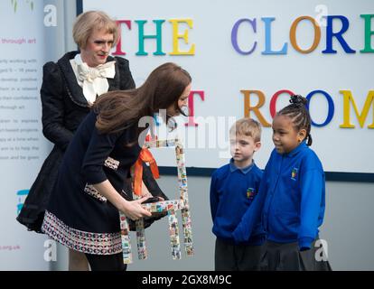 Catherine, Herzogin von Cambridge, trägt ein lockeres, passendes Mutterschaftskleid von Madderson und wird mit einem Pint-großen bedruckten Stuhl präsentiert, möglicherweise ein Geschenk für Prinz William, Während ihres Besuchs an der Barlby Primary School in West London, um am 15. Januar 2015 offiziell den Clore Art Room zu benennen, unterhielt sie sich mit dem mit dem Turner Prize ausgezeichneten Künstler Grayson Perry. Stockfoto