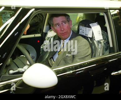 Der Prinz von Wales betrachtet einen Mini im Cowley-Werk von BMW in Oxfordshire während einer Tour durch die Produktionslinie. Der Prinz traf einige der 4,500 Mitarbeiter, die bei der Produktion des neuen Mini mithelfen, der im Juli 2001 eingeführt wurde. â©Anwar/allaction.co.uk Stockfoto