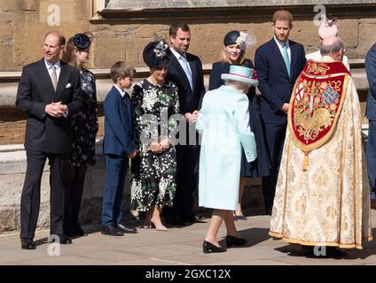 Königin Elizabeth ll wird von Familienmitgliedern (l bis r) Prinz Edward, Herzog von Wessex, Lady Louise Windsor, James, Viscount Severn, Sophie, Gräfin von Wessex, Peter Phillips, Autumn Phillips und Prinz Harry, Herzog von Sussex, während sie den Osterdienst in der St. George's Chapel in Windsor besucht Stockfoto