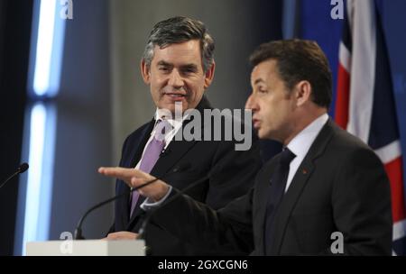 Der britische Premierminister Gordon Brown, links, hört zu, wie Frankreichs Präsident Nicolas Sarkozy am 27. März 2008 bei einem Gipfel im Emirates Stadium, dem Heimstadion des Fußballclubs Arsenal, in London, England, spricht. Der französische Präsident Nicolas Sarkozy und Carla Bruni-Sarkozy sind am zweiten und letzten Tag des Staatsbesuchs des französischen Präsidenten. Stockfoto