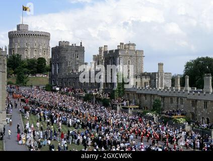 Die Prozession des Garter-Ordens webt sie aus Windsor Castle heraus und weiter in Richtung St. George's Chapel. Während der Zeremonie in der Kapelle investierte die Königin den Herzog von Gloucester, ihren Cousin, mit der Mitgliedschaft in Großbritanniens höherem Rittertum. Stockfoto