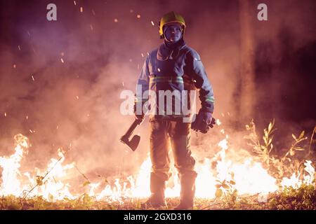 feuerwehrporträt auf authentischer Feuerstelle im Wald Stockfoto