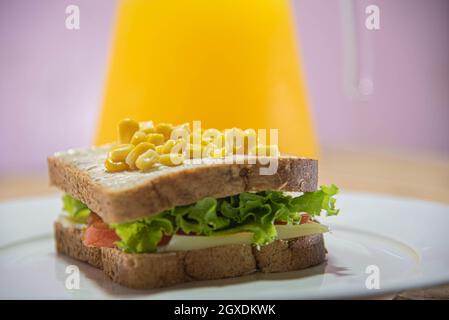 Hausgemachtes Sandwich mit Mais, Salat, Tomaten und Käse. Schnelle Zuführung. Fastfood. Brasilianische Küche. Stockfoto
