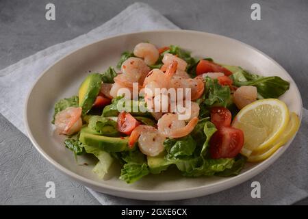 Avocado-Salat mit Garnelen und Kirschtomaten. Frühstück mit Meeresfrüchten Stockfoto