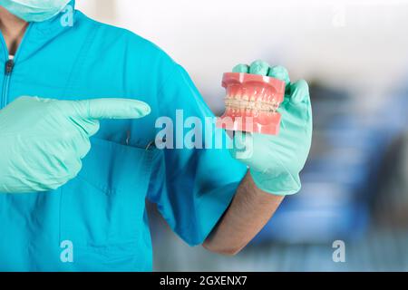 Zahnarzt Arzt zeigt, wie man ein Korsett anwenden Stockfoto