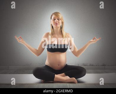 Schwanger entspannt sich und hält fit beim Yoga Stockfoto