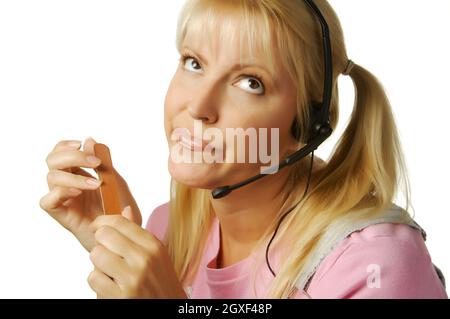 Ein offensichtlich gelangweiltes Kundendienstmädchen, das darauf wartet, dass die Uhr 5:00 Uhr erreicht. Stockfoto