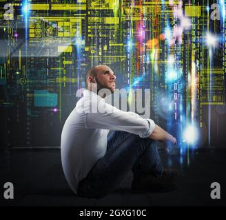 Mann, der mit Binärcodes im Hintergrund sitzt Stockfoto