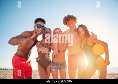 Eine Gruppe von Freunden, die gerne am Beachvolleyball am Strand Stockfoto