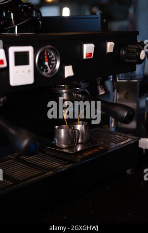 Nahaufnahme der Espressomaschine, die im Pub, in der Bar und im Restaurant Kaffee zubereitet. Professionelles Brühen von Kaffee. Café Cafeteria Restaurant Service Konzept. Stockfoto