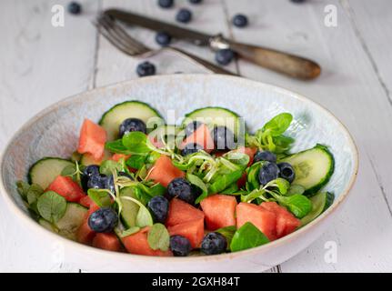 Hausgemachter Salat mit Obst und Gemüse wie Gurke, Wassermelone, Heidelbeeren und Lammsalat, mariniert mit Olivenöl und Apfelessig.´s Stockfoto