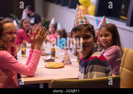 Der junge freudig feiert seinen Geburtstag mit einer Gruppe seiner Freunde Stockfoto