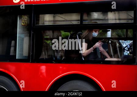 Frau saß im Sightseeing-Bus und schaute auf ihr Telefon, Barcelona, Spanien. Stockfoto