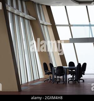 Tagungsraum mit weißen modernen Tisch Büro und orangefarbene Stühle mit Glaswand Stockfoto