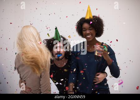 Konfetti Party Multiethnics glückliche junge Menschen Gruppe feiern Silvester beim Tanzen und viel Spaß zu Hause Stockfoto