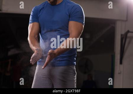 Fitness-Studio Kreide Magnesiumcarbonat Hände klatschenden Mann zum Klettern Training Stockfoto