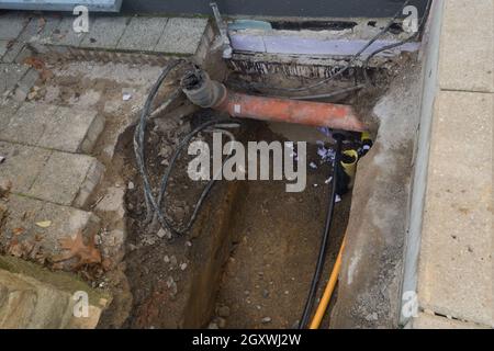 Arbeiten an der Installation von Engineering- und Heizsystemen. Zwei Kunststoffrohre, eine gelbe für Gasleitung und eine schwarze für Stromleitungen. Sie befinden sich in einer SA Stockfoto