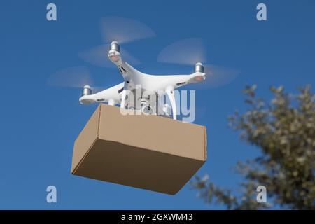 UAV-Quadcopter-Drohne (Unmanned Aircraft System), das Paket liefert. Stockfoto