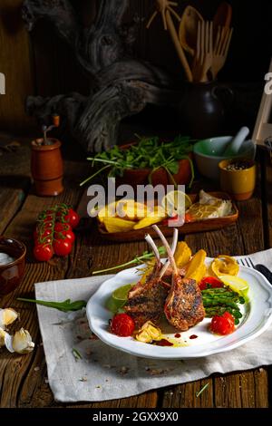 Lammkoteletts in Kräutern mit grünem Spargel und Limette mariniert Stockfoto